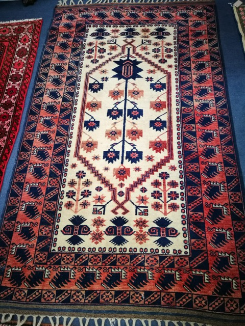 A North West Persian ivory ground rug 190 x 112cm